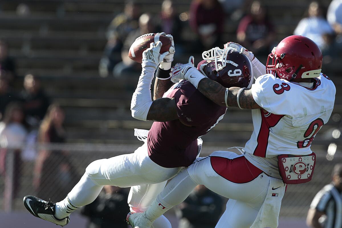 Mt. SAC defensive back Joseph Bryant intercepts a pass intended for City College of San Francisco receiver Rodney Lawson in the first half Saturday.