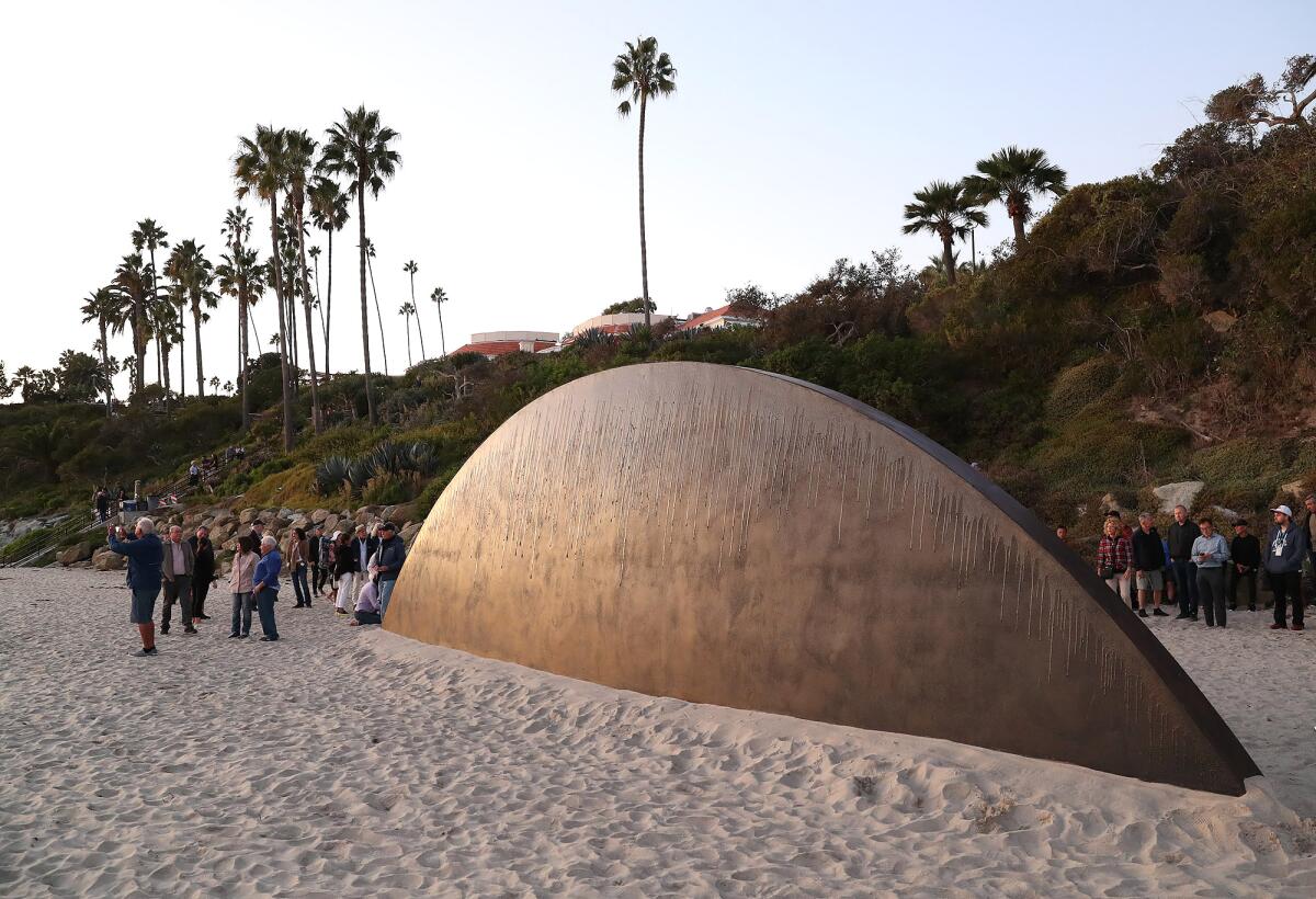 Artist Cristopher Cichocki's "Rising Inversion" is set against a hillside at Main Beach Park in Laguna Beach.