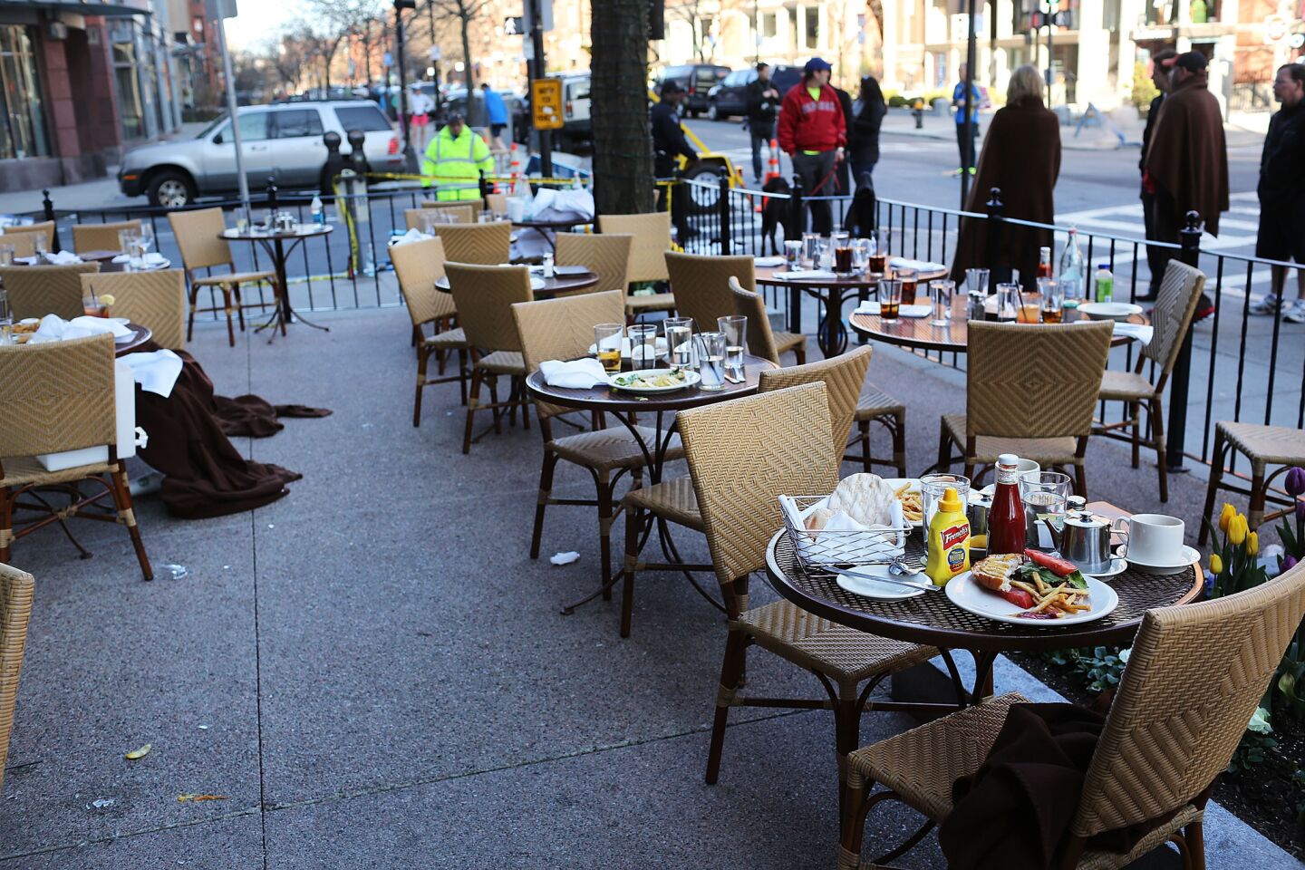 The unfinished meals of fleeing customers are left on tables at an outdoor restaurant near the scene of twin bombings at the Boston Marathon.
