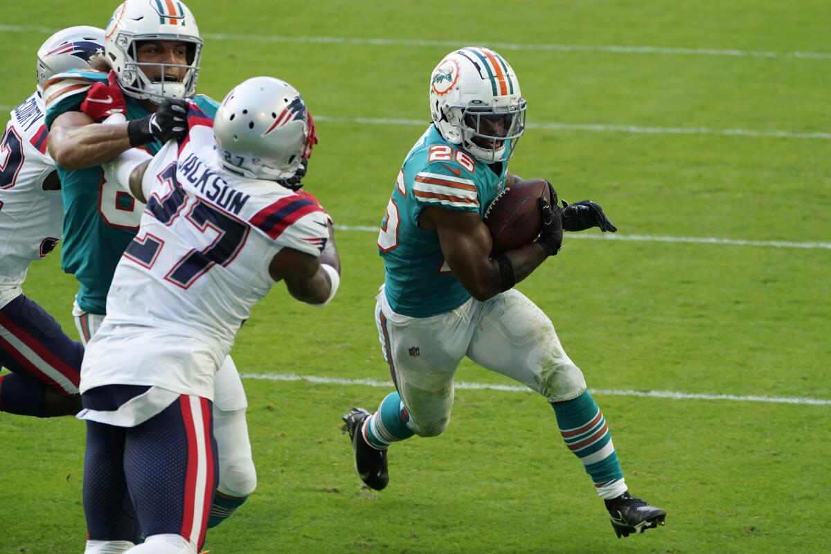 Miami Dolphins running back Salvon Ahmed scores a two-point conversion against the Patriots.