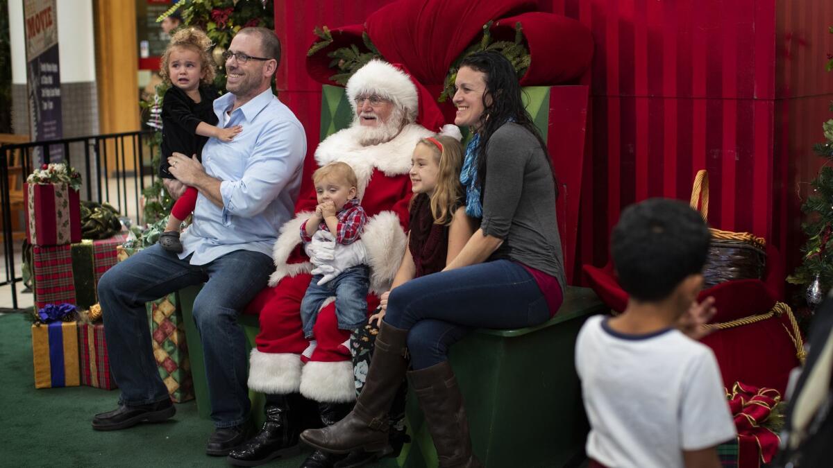 The McCluskey family of Chico gets a photo taken with Santa at the Chico Mall. In light of the Camp fire tragedy, families are bringing their children some Christmas cheer.
