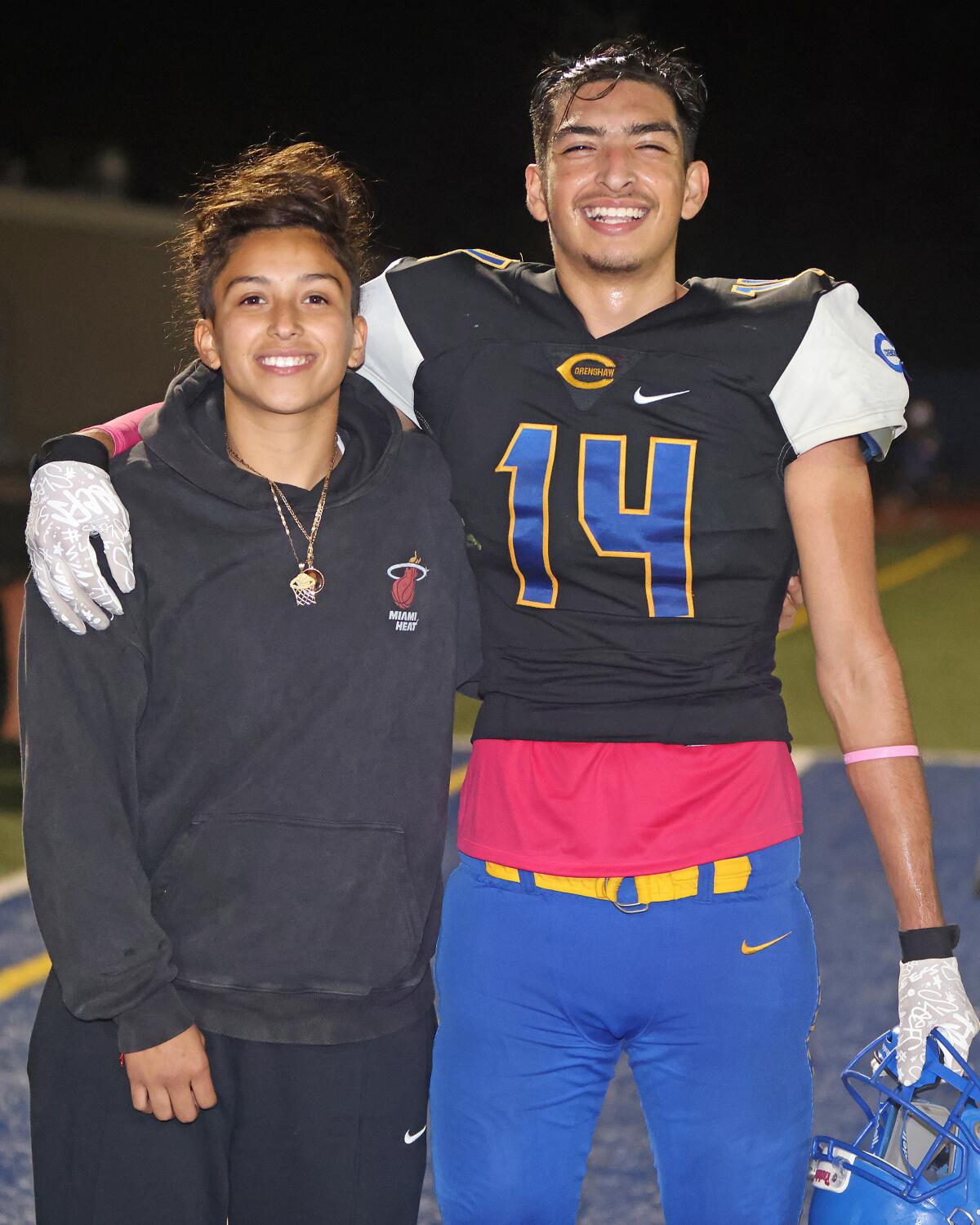 Crenshaw kicker/punter Roberto Salazar celebrates with sister, Citlali, after making game-winning field goal against Dorsey.