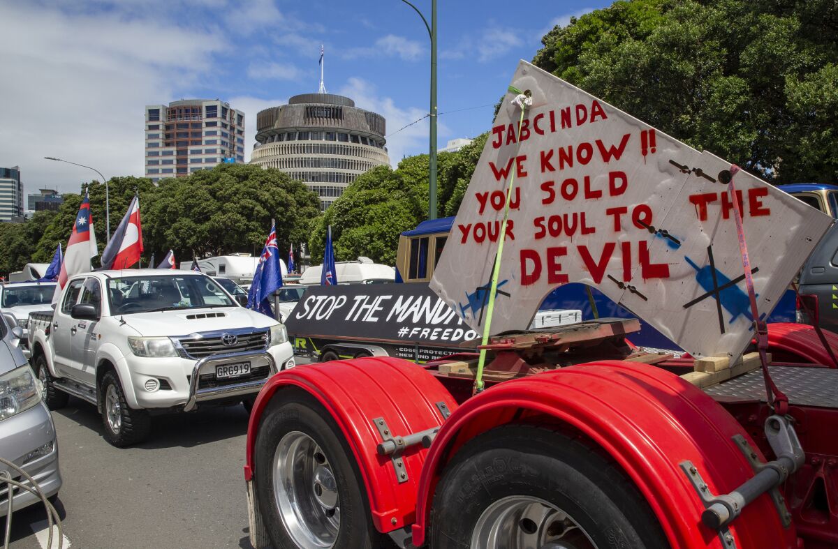 A convoy of vehicles block a road near New Zealand's Parliament in Wellington Tuesday, Feb. 8, 2022. Hundreds of people protesting vaccine and mask mandates drove in convoy to New Zealand's capital on Tuesday and converged outside Parliament as lawmakers reconvened after a summer break. (Mark Mitchell/New Zealand Herald via AP)