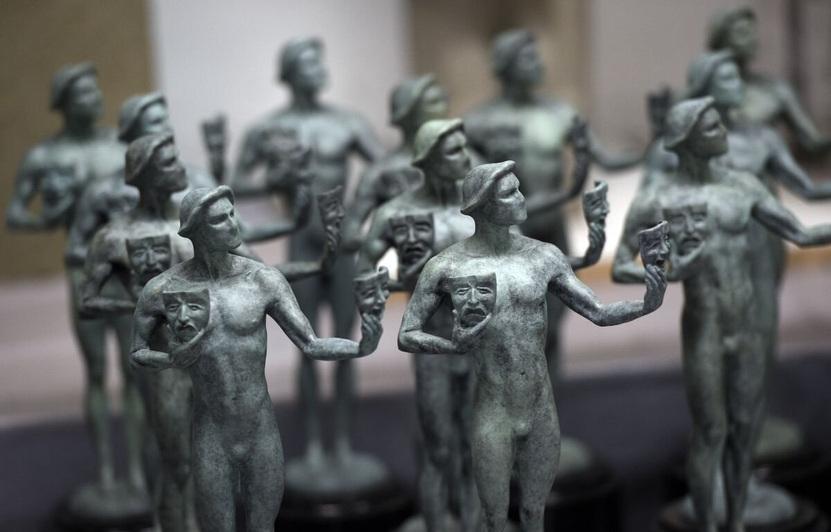 FILE - Finished solid bronze Actor statuettes are displayed during the 25th Annual Casting of the Screen Actors Guild Awards at American Fine Arts Foundry, Tuesday, Jan. 15, 2019, in Burbank, Calif. The 2022 SAG Awards are scheduled to take place on Feb. 27. (Photo by Chris Pizzello/Invision/AP, File)