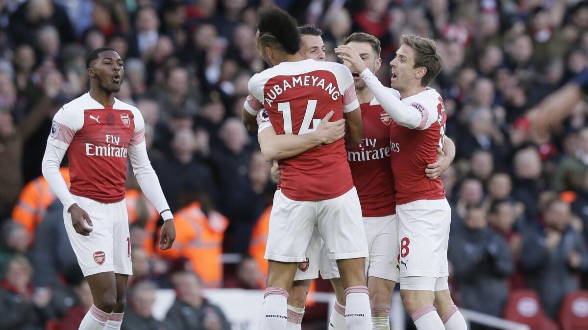 Arsenal players celebrate after scoring a goal against Manchester United on March 10.
