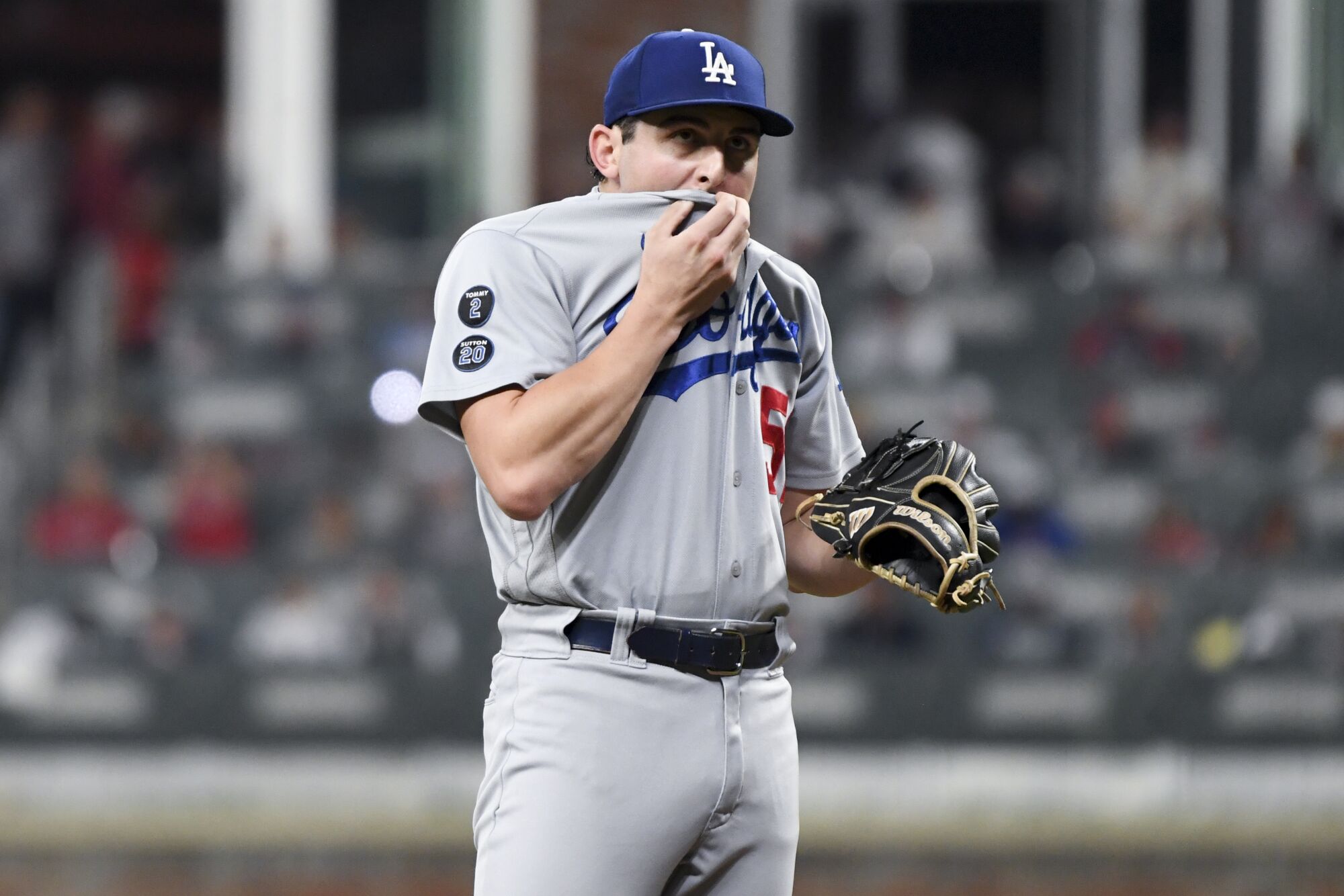 Los Angeles Dodgers relief pitcher Alex Vesia reacts after walking Atlanta Braves' Ozzie Albies to load the bases