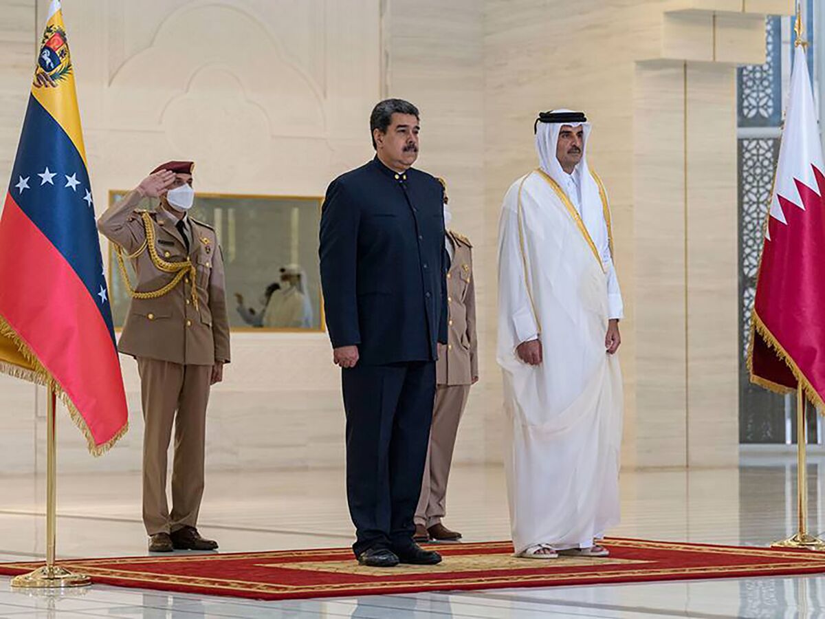 In this photo released by Qatar News Agency, QNA, Qatari Emir Sheikh Tamim bin Hamad Al-Thani, right, receives Venezuela's President Nicolas Maduro in Doha, Qatar, Wednesday, June 15, 2022. (QNA via AP)