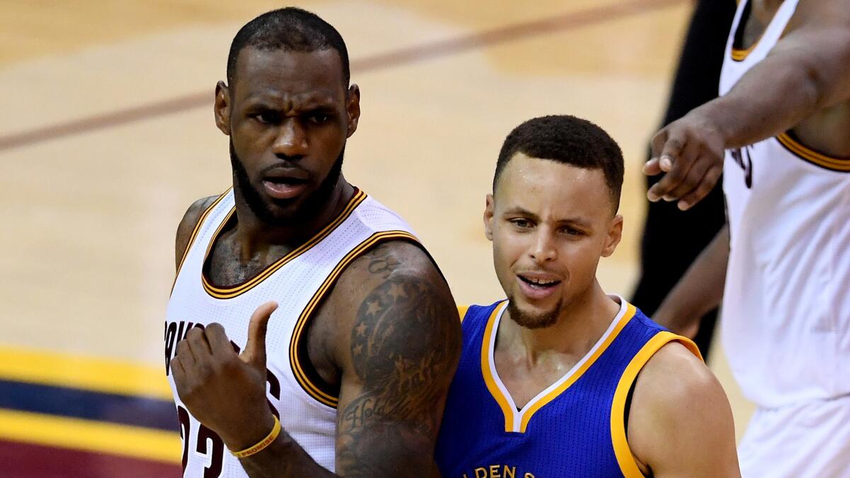 Cavaliers forward LeBron James and Warriors guard Stephen Curry wait to hear the result of a foul call during Game 6 of the NBA Finals.