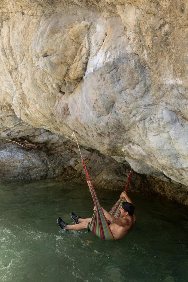 A visitor swings in a hammock at Stoddard Canyon Falls and Slide.