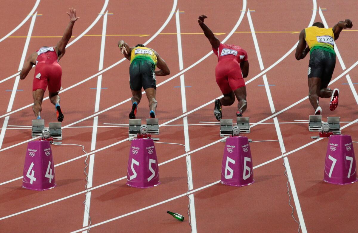 A bottle is thrown onto the track at the start of the men's 100-meter final at the London 2012 Olympic Games on August 5, 2012.