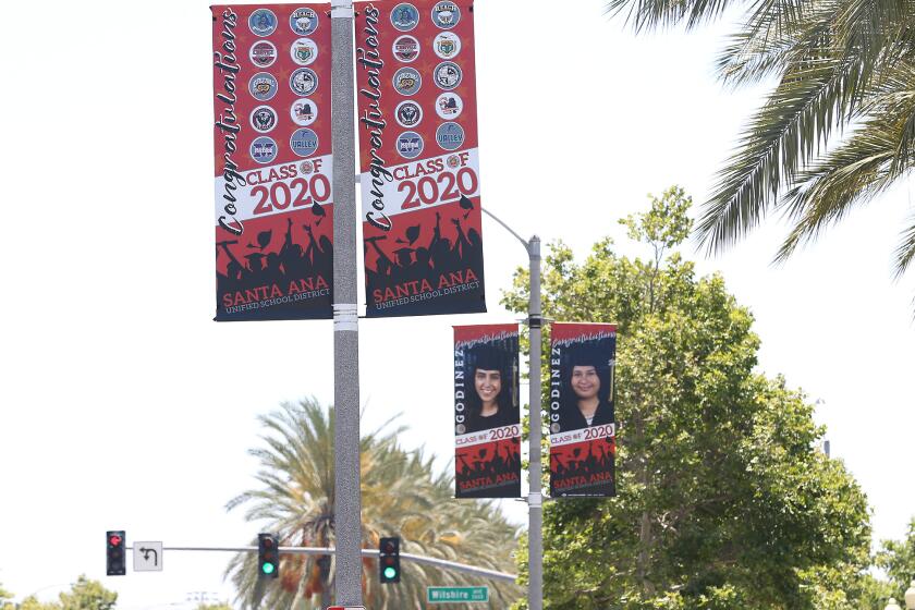 Banners celebrating 2020 graduates are shown on light pole along Bristol in Santa Ana.