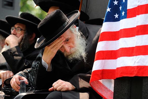 Amid an East Coast heat wave, an Orthodox Jewish man takes part in a protest coinciding with a visit to Washington by Israeli Prime Minister Benjamin Netanyahu.