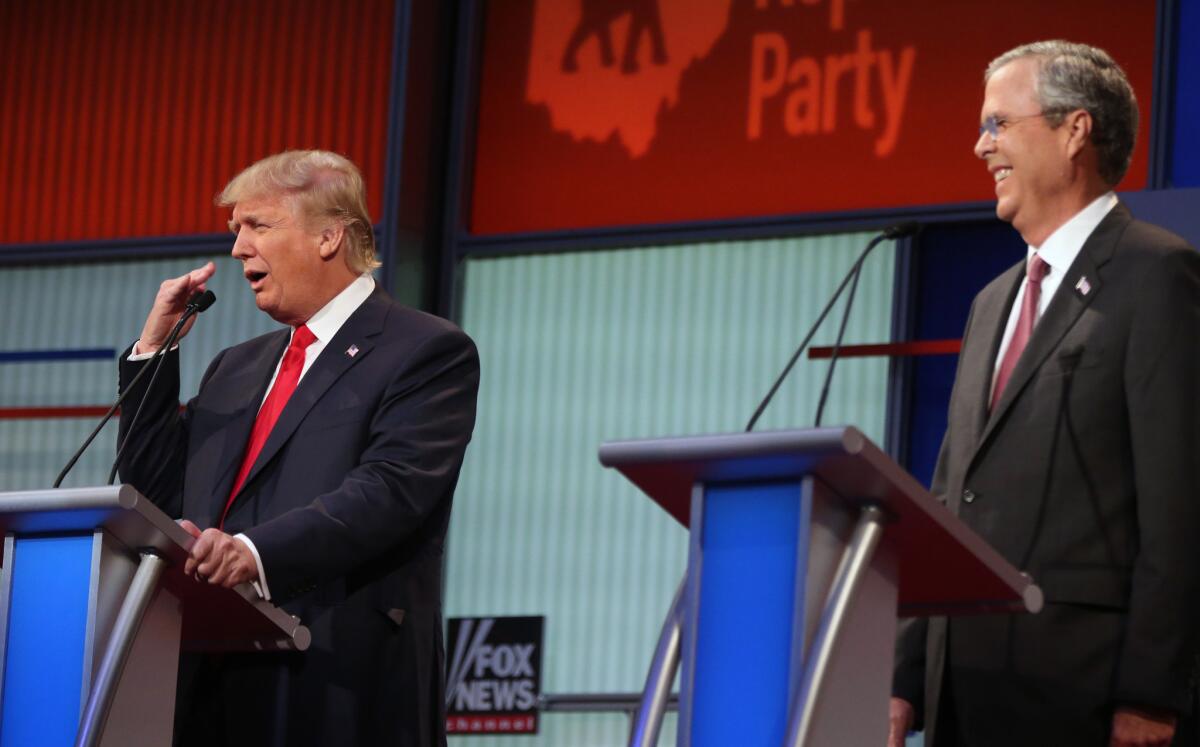 Republican presidential candidates Donald Trump, left, and Jeb Bush on the debate stage in Cleveland.