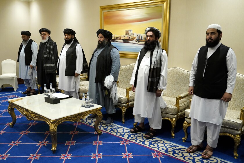 Members of the Taliban's peace negotiation team meet with Secretary of State Mike Pompeo amid talks between the Taliban and the Afghan government, Saturday, Nov. 21, 2020, in Doha, Qatar. (AP Photo/Patrick Semansky, Pool)