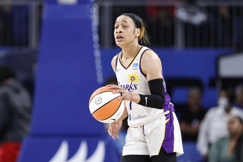 Los Angeles Sparks guard Chennedy Carter brings the ball up court against the Chicago Sky during the first half of the WNBA basketball game, Friday, May 6, 2022, in Chicago. (AP Photo/Kamil Krzaczynski)