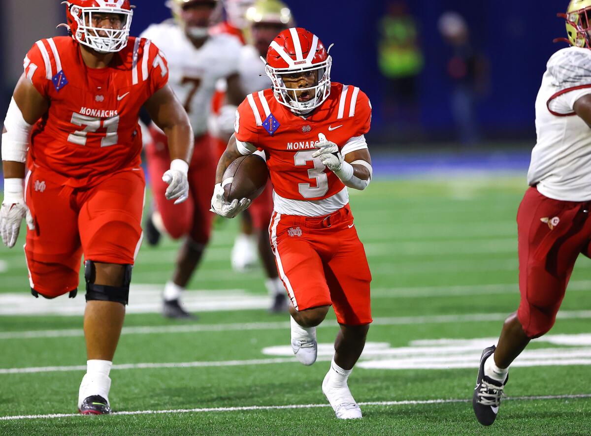 Ajon Bryant of Mater Dei takes off with his best friend, Sione Tohi (71), running interference.