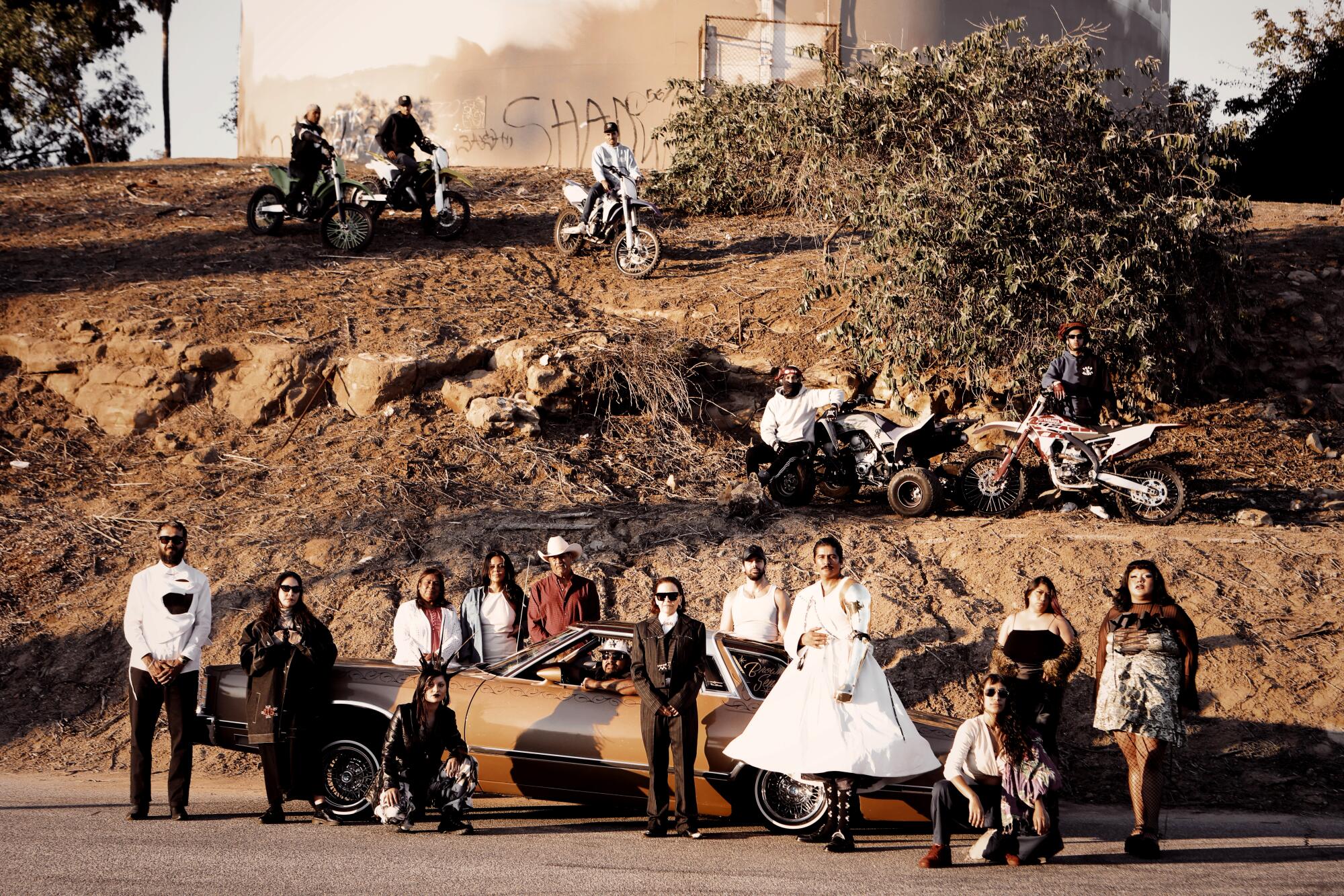 rafa esparza with family and friends in Elysian Park, a lowrider car in the background