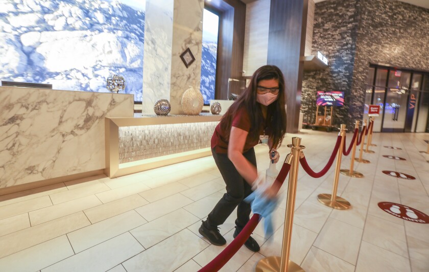 Preparing for reopen, Sycuan Casino front desk manager Kathryne Chavez cleans and sanitizes the hotel lobby/front desk check-in area at Sycuan Casino on May 15, 2020.