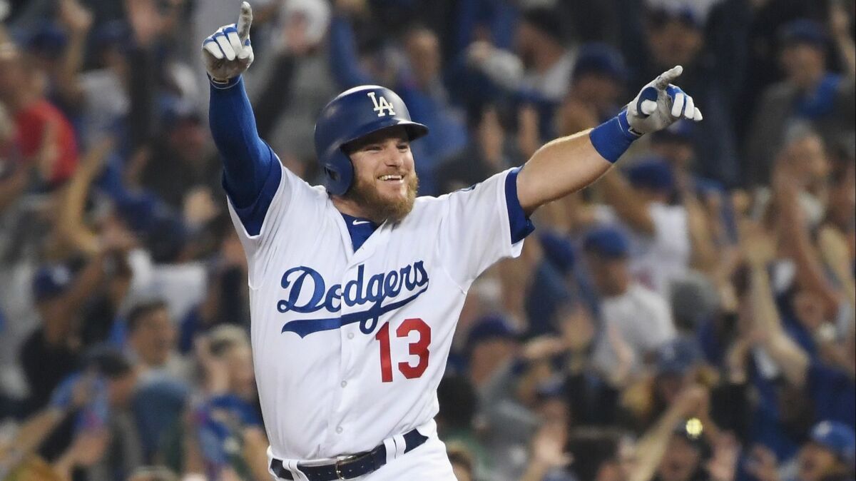 The Dodgers' Max Muncy celebrates his 18th inning walk-off home run to defeat the the Boston Red Sox 3-2 in Game Three of the 2018 World Series at Dodger Stadium on October 26, 2018 in Los Angeles, California.