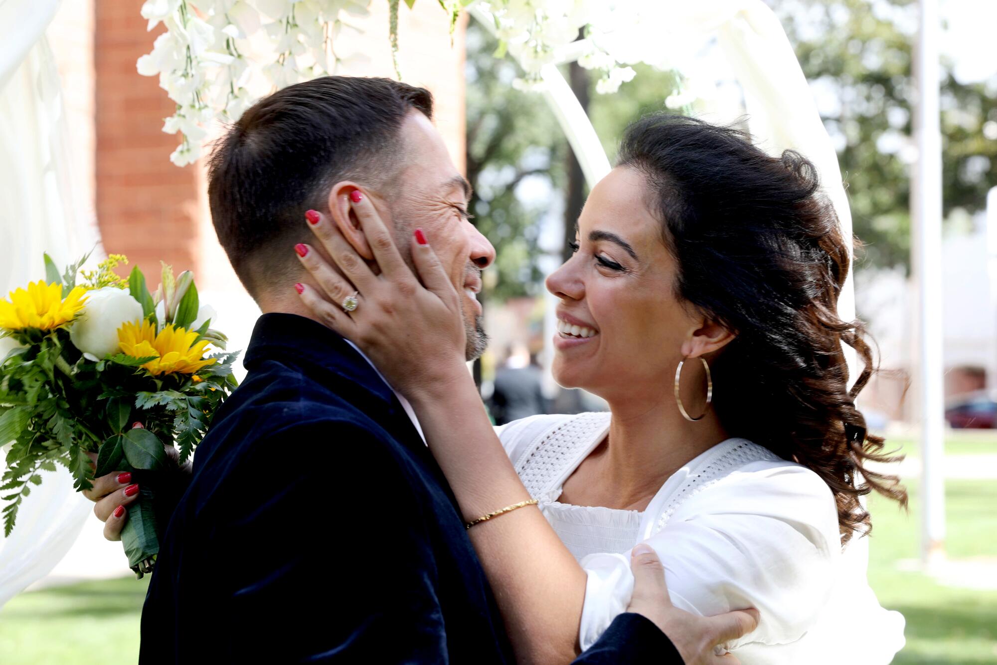 Newlyweds Enrique and Afrouz Alvarez kiss at the Old Orange County Courthouse.