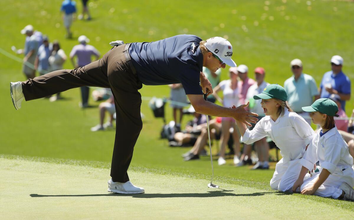 Charley Hoffman gets congratulations from daughters Claire and Katelynn during the par-three contest.