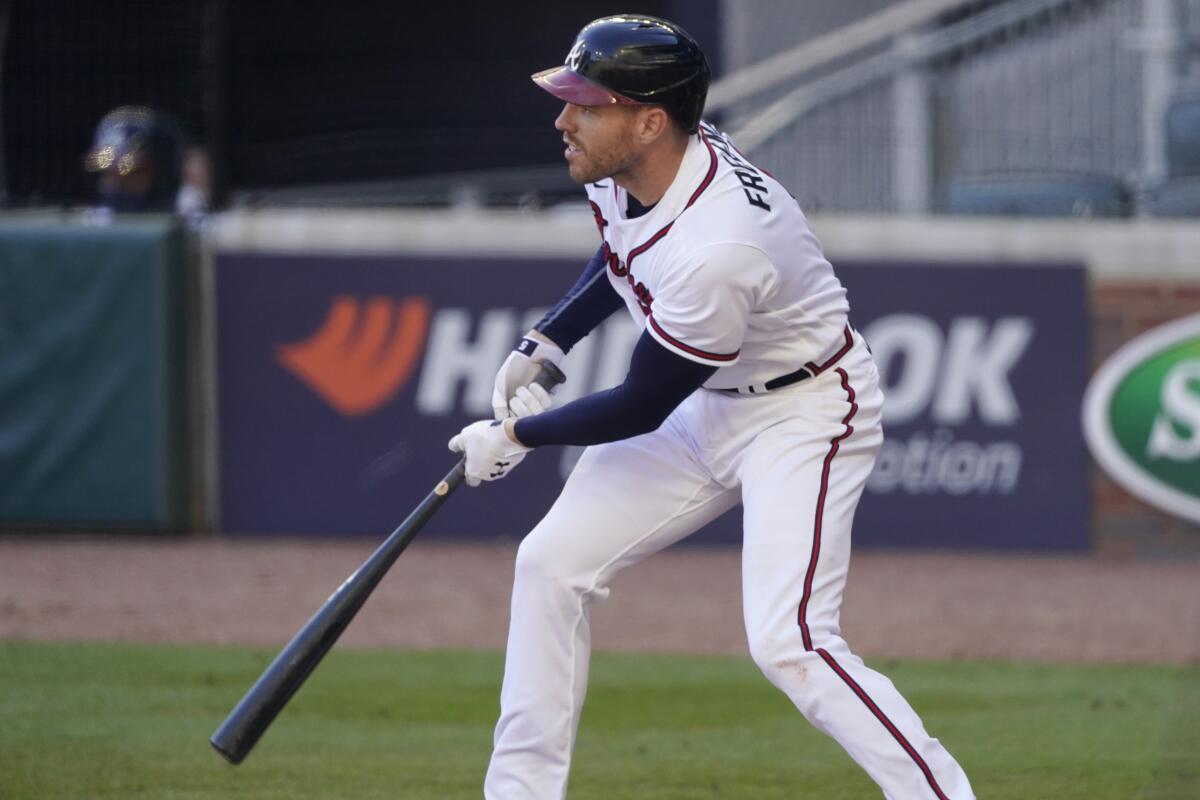 Atlanta Braves' Freddie Freeman follows through on his game-winning base hit against the Cincinnati Reds.