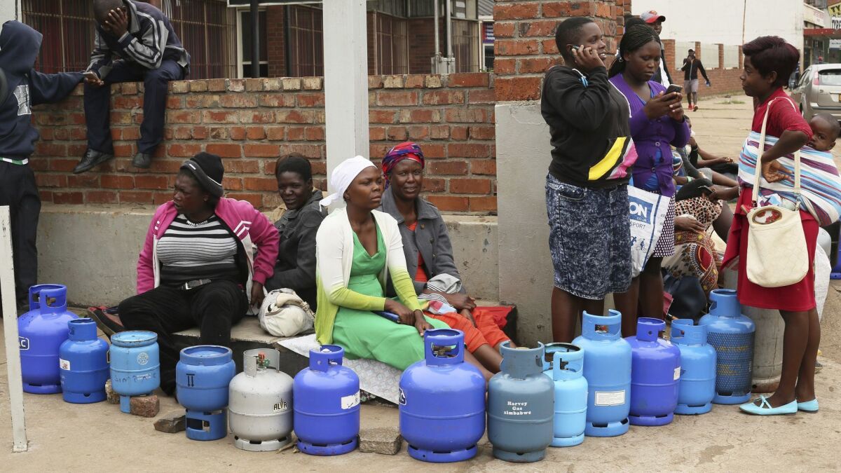 People wait in line for cooking gas at a garage in the Zimbabwean capital of Harare on Wednesday, Jan. 23, 2019.
