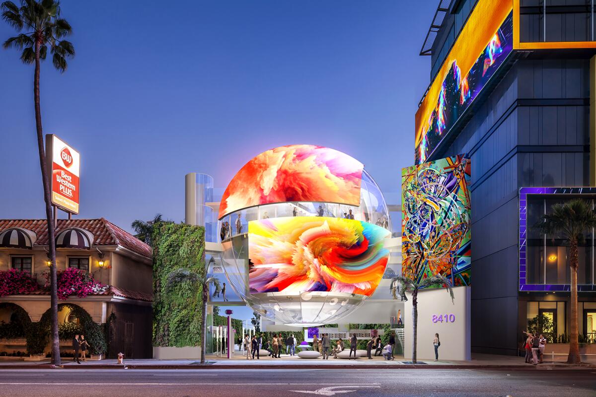 A spherical structure is scene with colorful advertising.