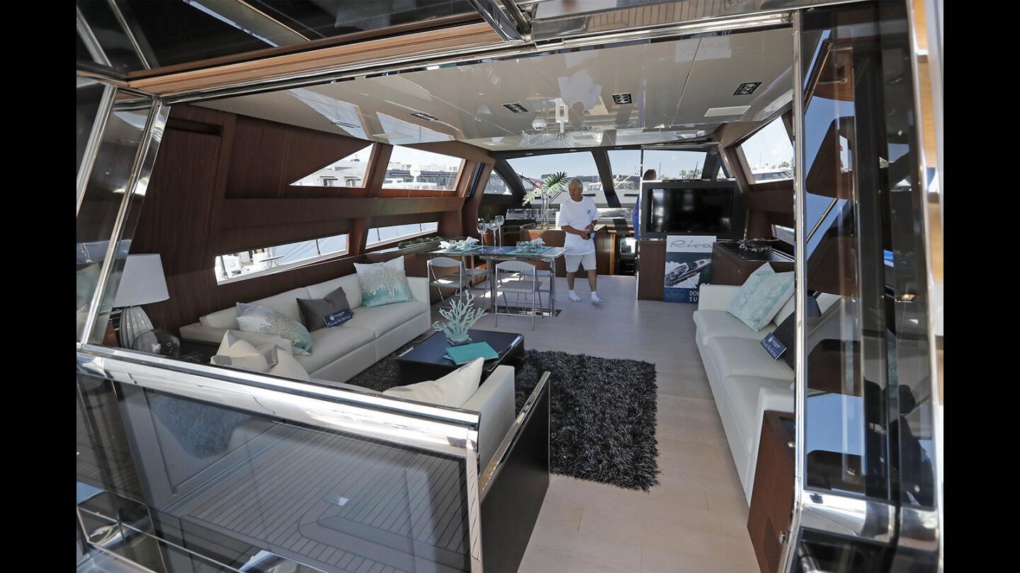 A visitor views the inside of a Riva 88 Domino Super luxury motor yacht Thursday during opening day of the 46th annual Newport Boat Show at Lido Marina Village in Newport Beach. The yacht retails for $8.86 million.