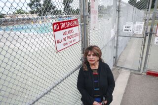Gloria Salas stands outside of the Las Palmas Municiple Pool on Tuesday, November 23, 2021 in National City. Las Palmas public pool in National City is getting a $2M renovation. Residents who have been advocating for upgrades share their excitement.(Photo by Sandy Huffaker for The San Diego Union-Tribune)