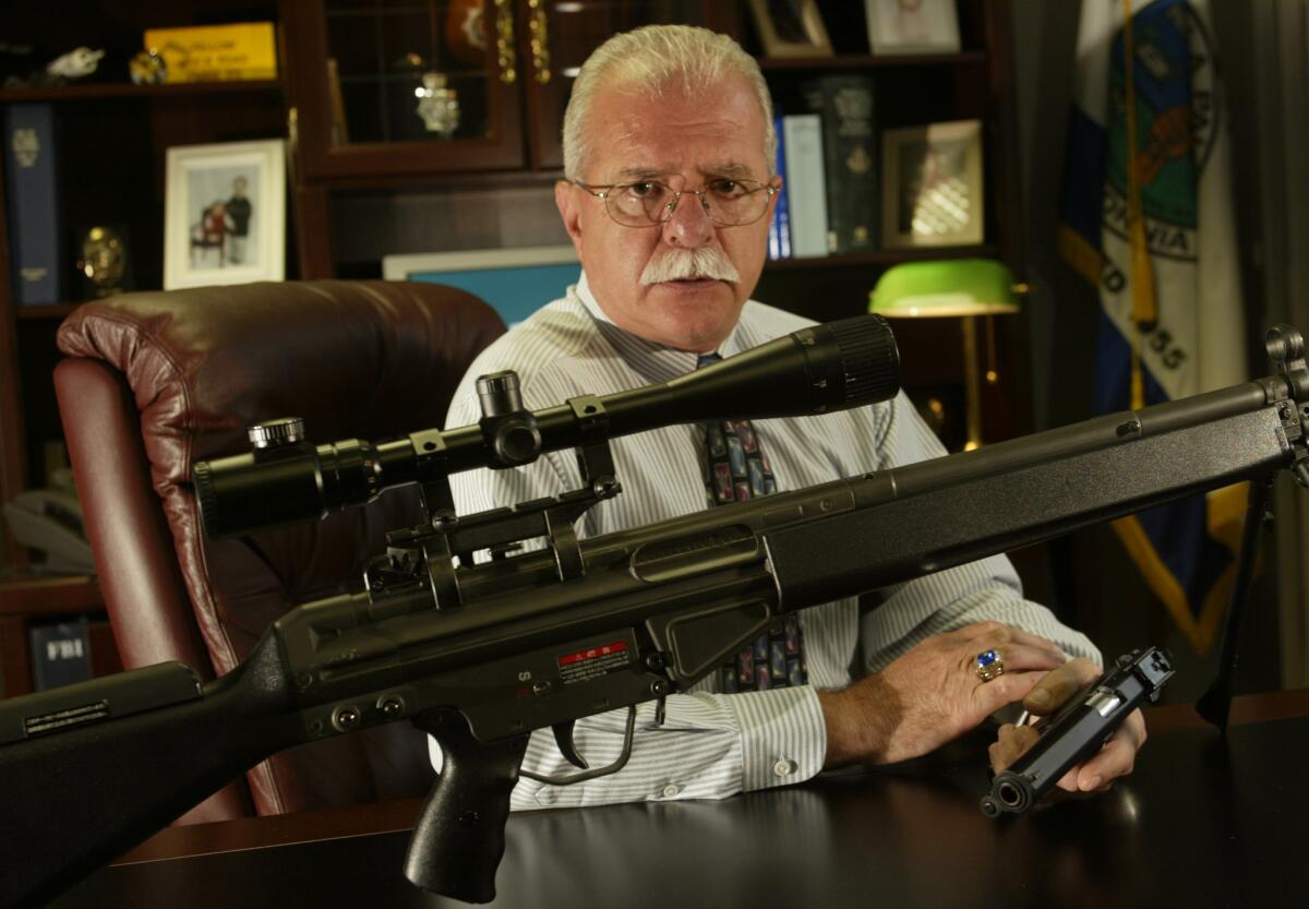 An airsoft rifle on the desk of former La Palma police chief Vincent Giampa looks like a genuine assault rifle. Legislation that cleared the California Senate on Tuesday would require such guns to be painted bright colors.
