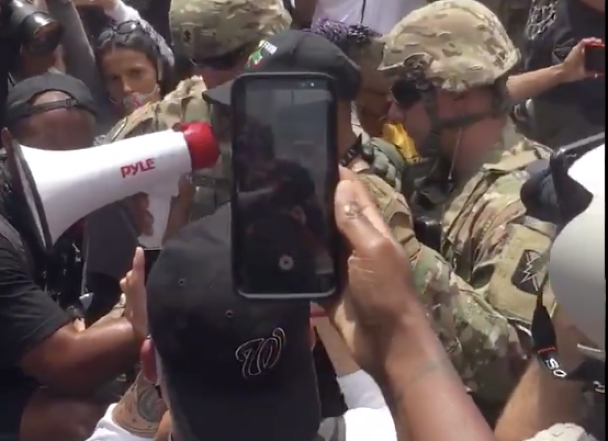 A National Guard member takes a knee during a Hollywood protest.