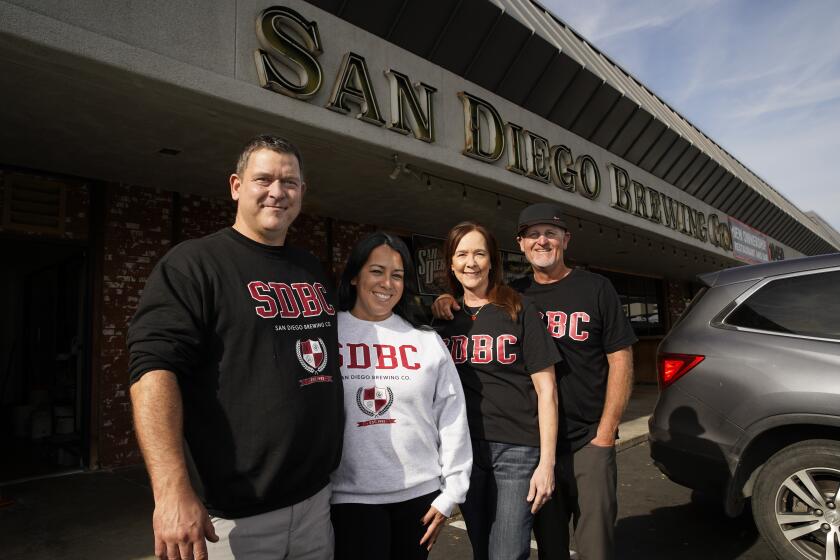 San Diego, CA - December 11: Tyson and Kristina Blake with Lisa and BobTownsend are co-owners of San Diego Brewing. They celebrate 30 years in business. They pose for a photo in Grantville on Monday, Dec. 11, 2023 in San Diego, CA. (Alejandro Tamayo / The San Diego Union-Tribune)