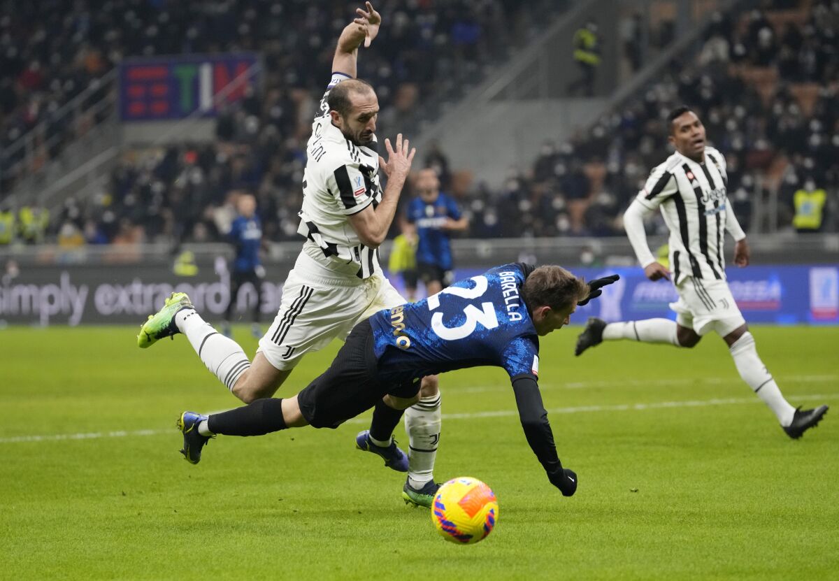 Juventus defender Giorgio Chiellini, left, challenges Inter Milan's Nicolo Barella for the ball.