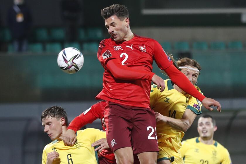 FILE - Switzerland's Fabian Schar heads the ball during the World Cup 2022 Group C qualifying soccer match between Lithuania and Switzerland at LFF stadium in Vilnius, Lithuania, on Oct. 12, 2021. (AP Photo/Mindaugas Kulbis, File)