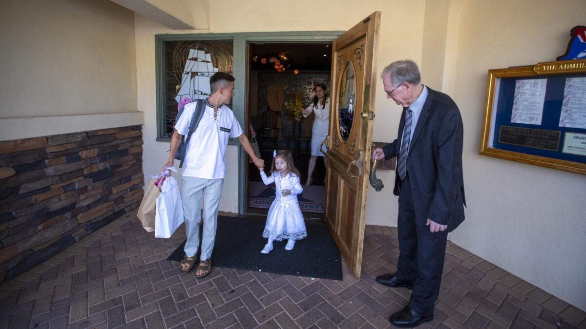 Wayne Judah, right, owner of the Admiral Risty, holds the door open for restaurant guests on Sunday.