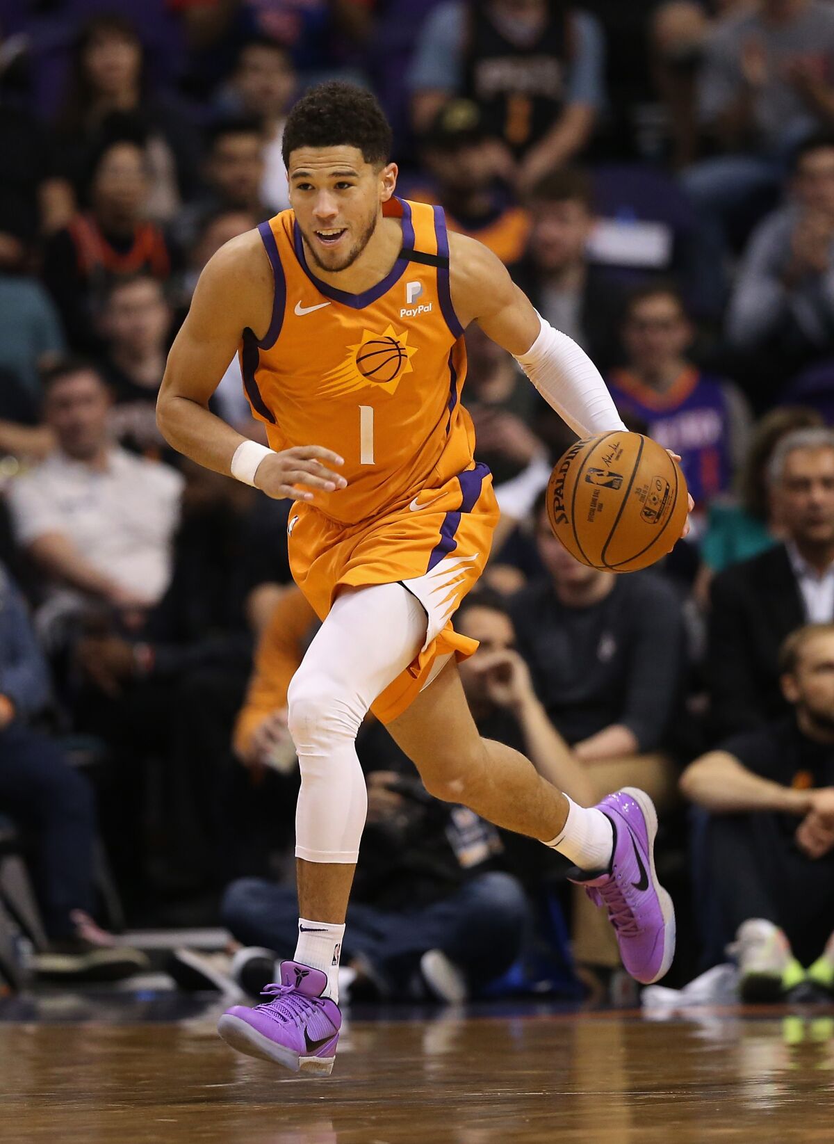 Suns guard Devin Booker handles the ball against the Detroit Pistons on Feb. 28, 2020, in Phoenix.