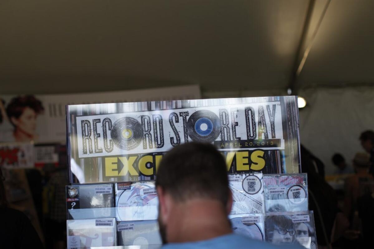 A shopper at last year's Coachella Valley Music and Arts Festival browses the onsite shop on Record Store Day.