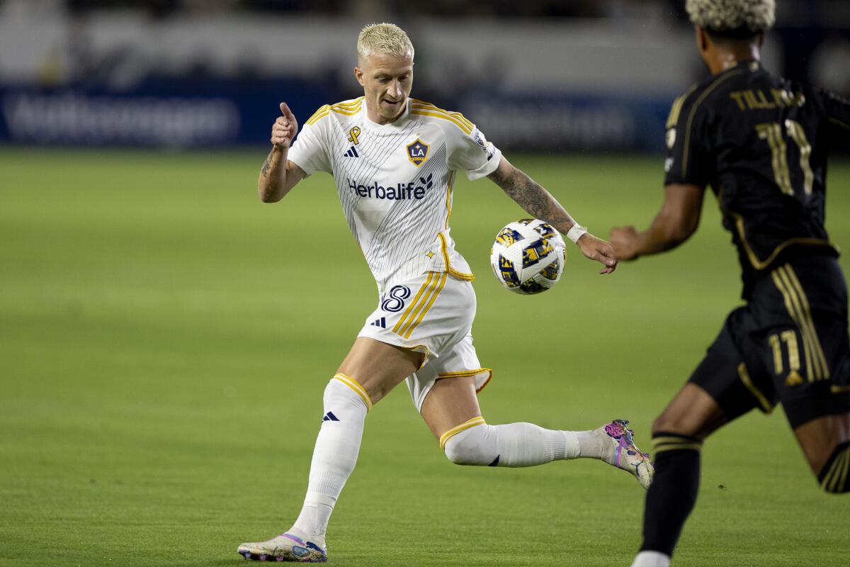 Galaxy forward Marco Reus, left, controls the ball in front of LAFC midfielder Timothy Tillman