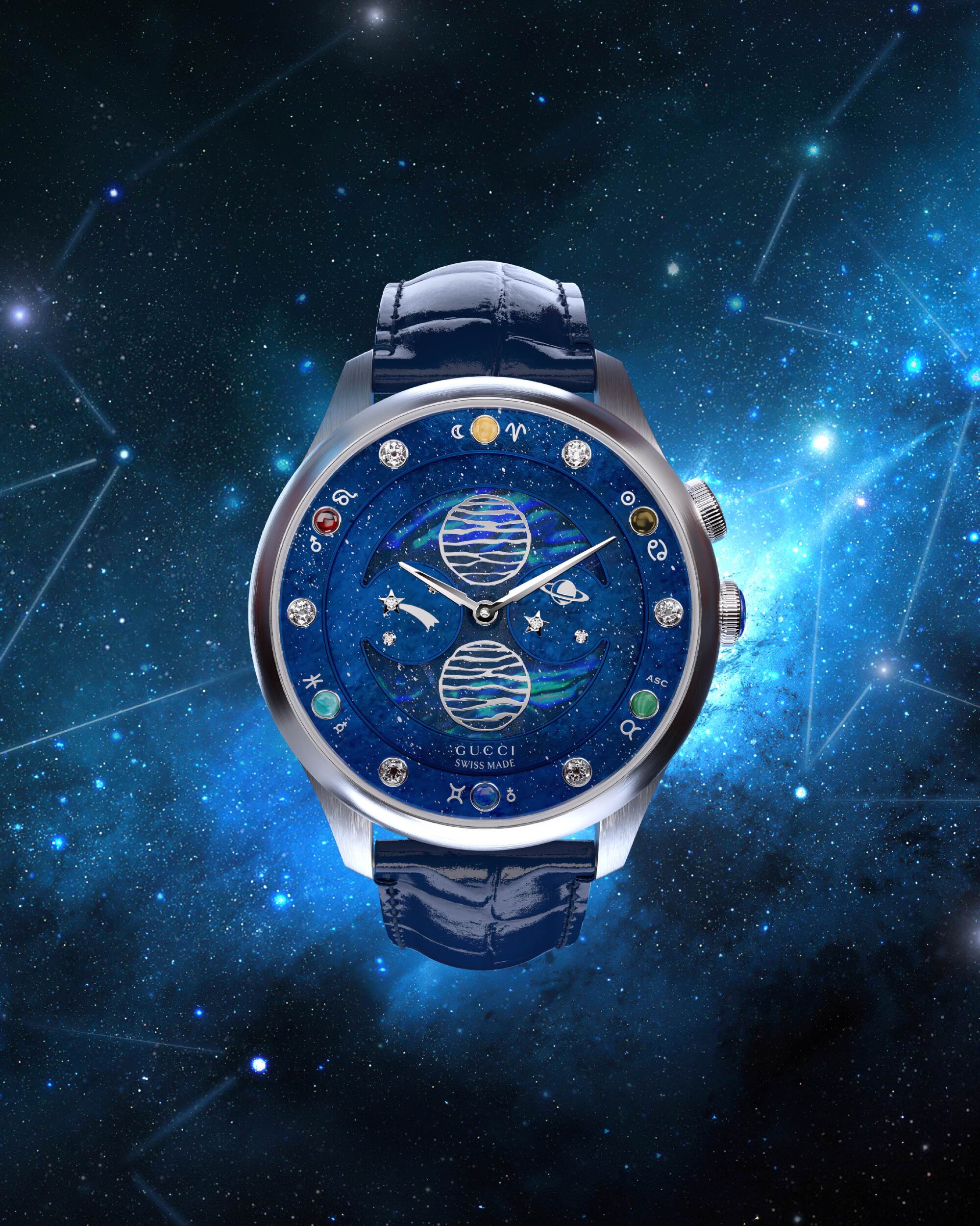 A blue-faced wristwatch against a starry-sky background