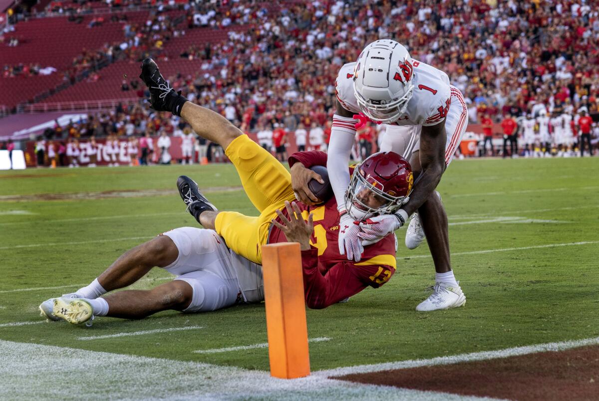 USC quarterback Caleb Williams is stopped just short of the goal line by Utah's Jonah Elliss and Miles Battle.