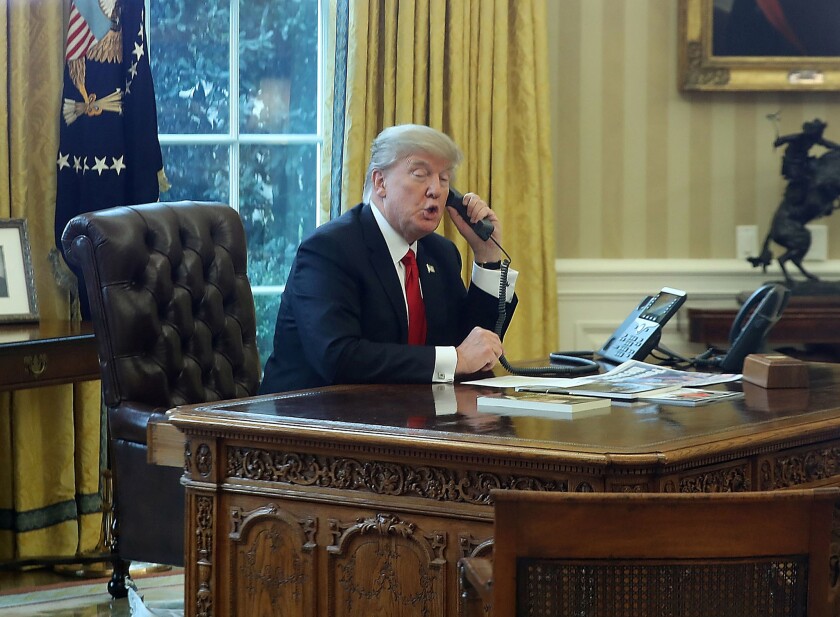 President Trump on the phone in the Oval Office on Jan. 29, 2017.
