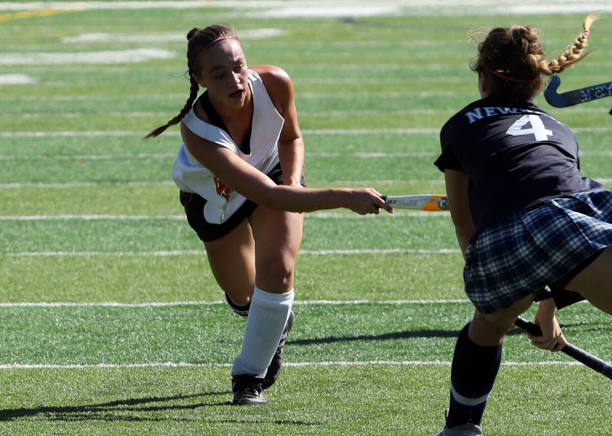 Huntington Beach's Lily Robertson (55) passes in a field hockey match. (James Carbone)