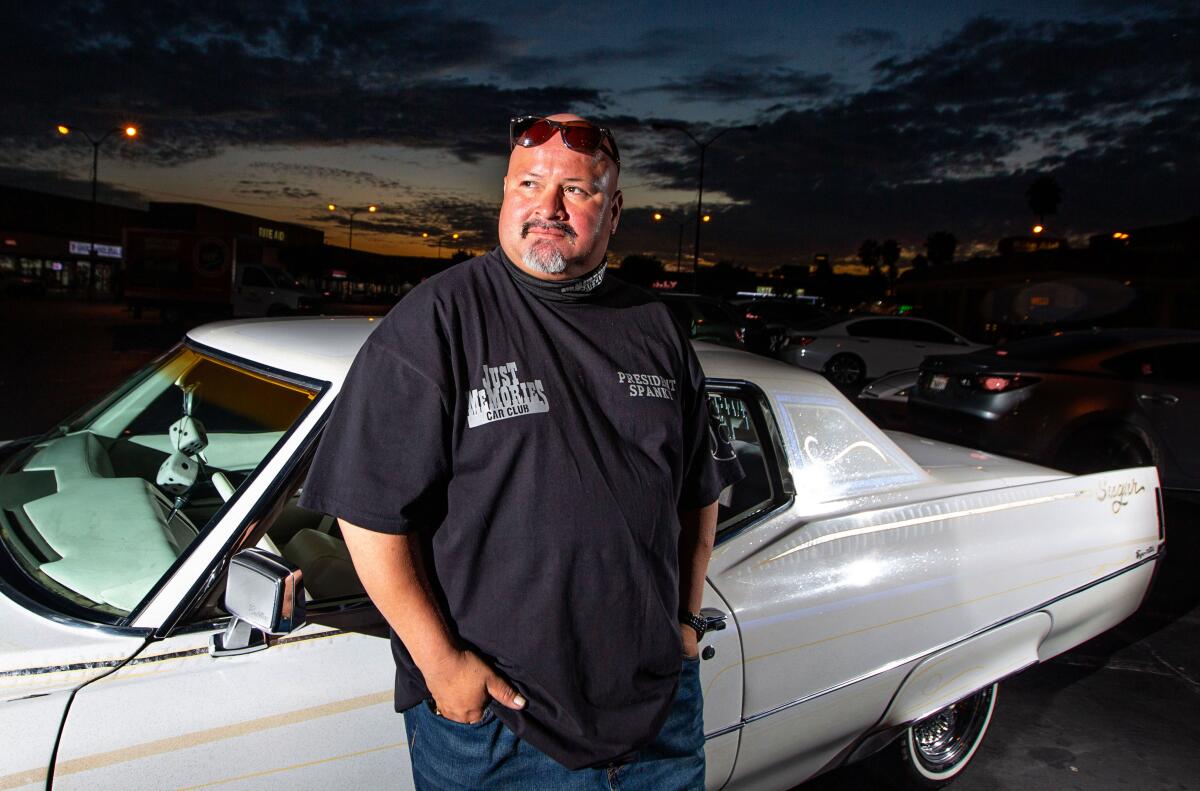 Juan "Spanky" Ramirez of Baldwin Park poses with his lowrider in East Los Angeles.