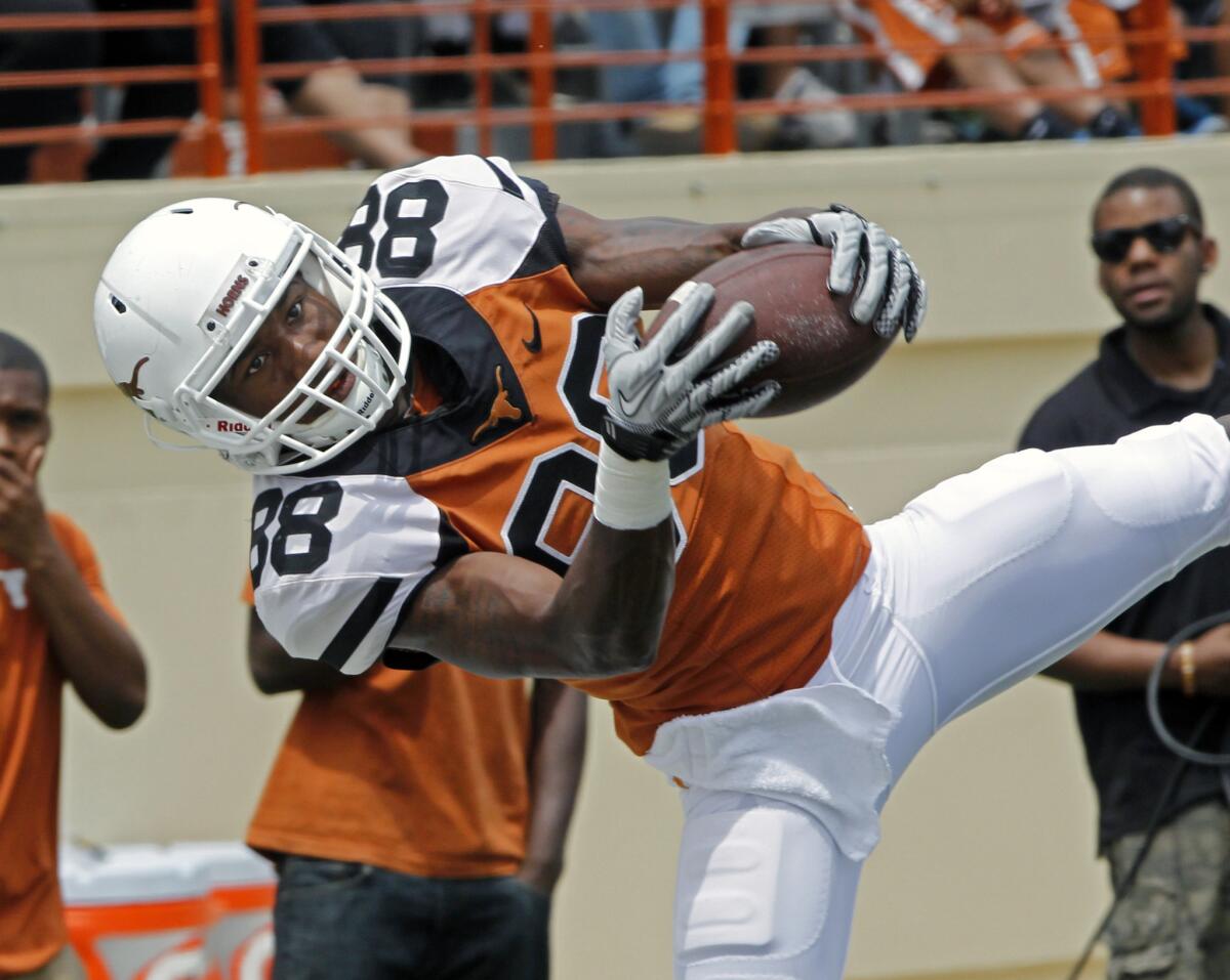 University of Texas football player Montrel Meander comes down with a pass during the first half of the Orange and White football game in Austin, Texas, on April 19. Meander and another Texas football player, Kendall Sanders, were charged with sexual assault Thursday.