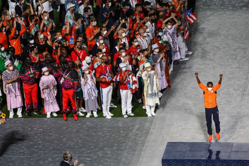 Tokyo, Japan, Sunday, August 8, 2021 - Abdi Nageeye of the Netherlands celebrates his Marathon Silver Medal in front of dancers and fellow athletes at theTokyo 2020 Olympics Closing Ceremony at Olympic Stadium. (Robert Gauthier/Los Angeles Times)