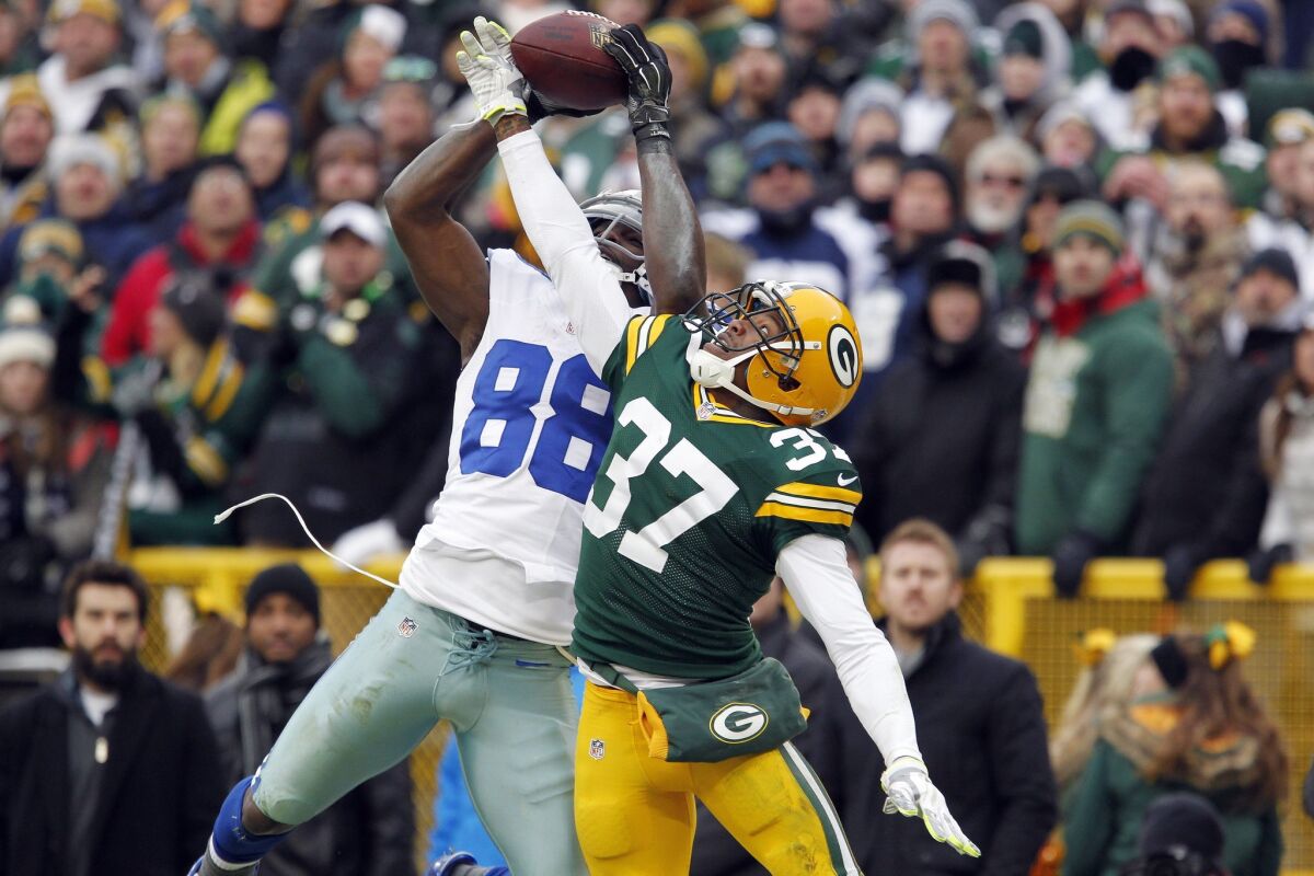 Dallas Cowboys wide receiver Dez Bryant grabs a pass over Green Bay Packers cornerback Sam Shields on Jan. 11. The play was initially called a catch but was reversed on review.