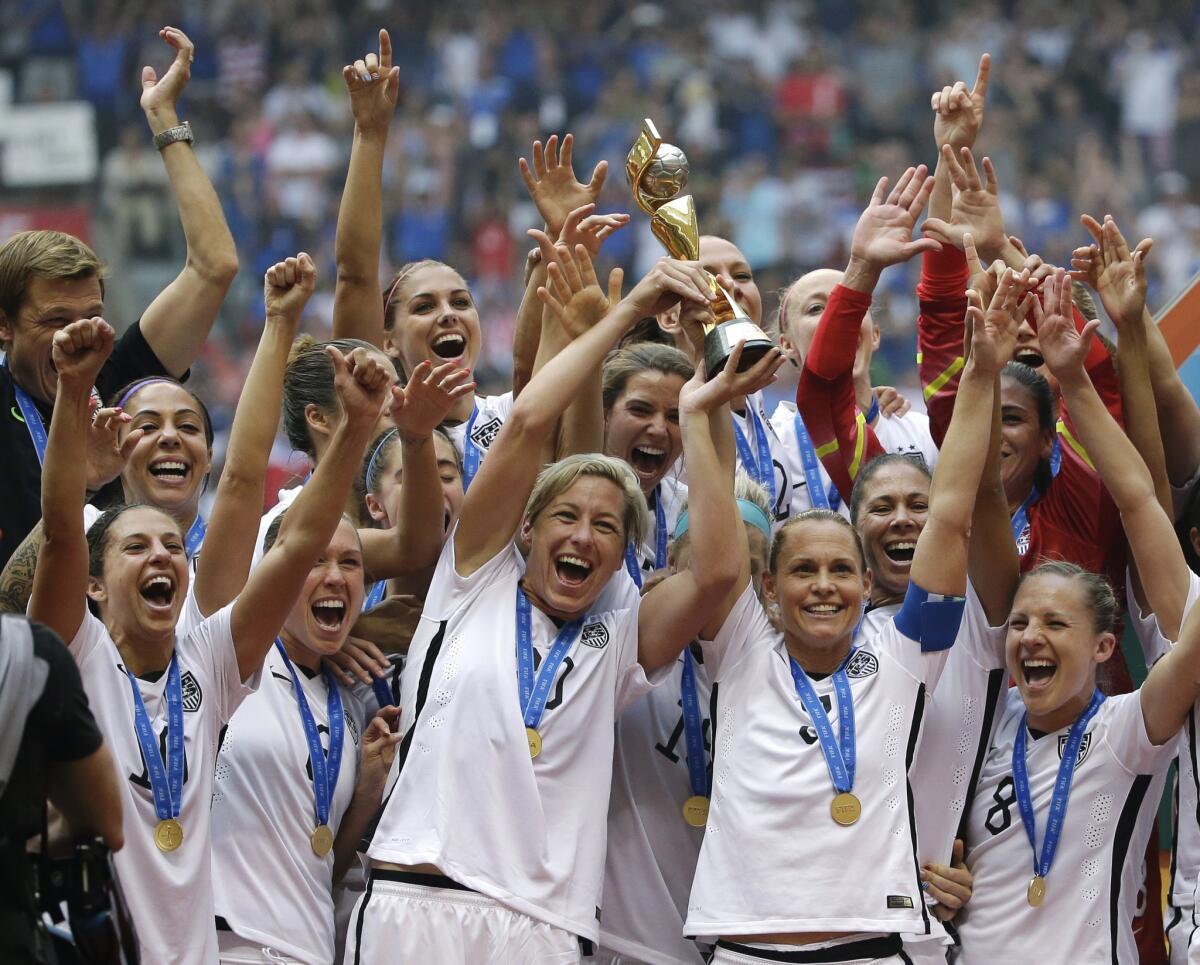 The United States Women's National Team celebrates with the trophy after they beat Japan 5-2 in the FIFA Women's World Cup soccer championship in Vancouver, Canada last July.