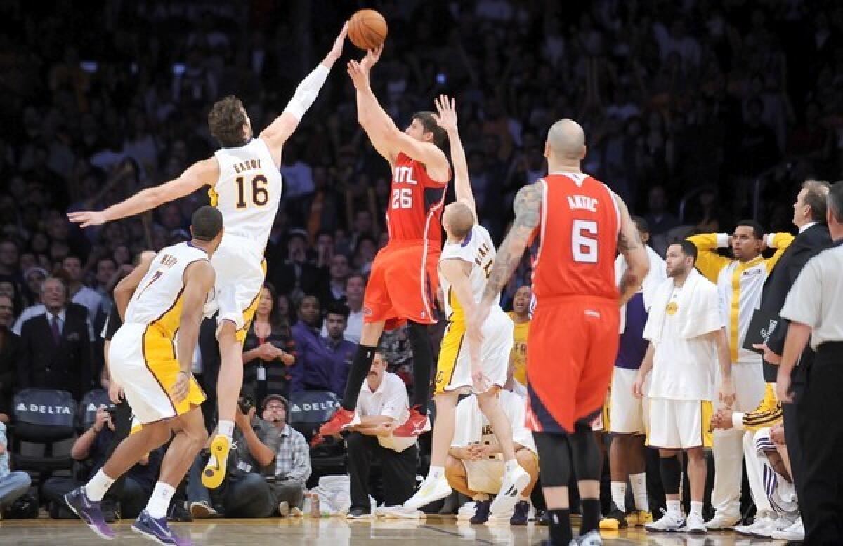 Lakers forward Pau Gasol, left, blocks a three-point attempt by Atlanta Hawks forward Kyle Korver in the closing seconds of the Lakers' 105-103 win at Staples Center.