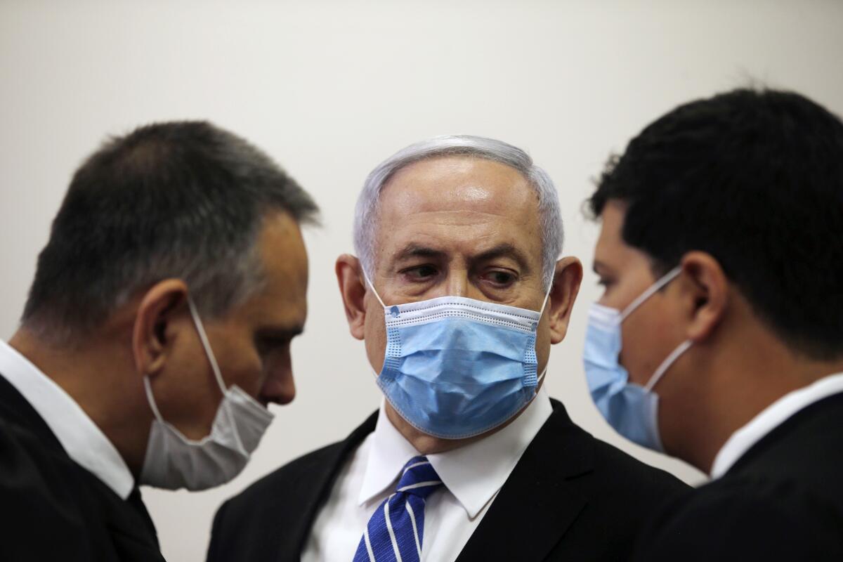 Israeli leader Benjamin Netanyahu, shown in court on Sunday, is charged with fraud, bribery and breach of trust.